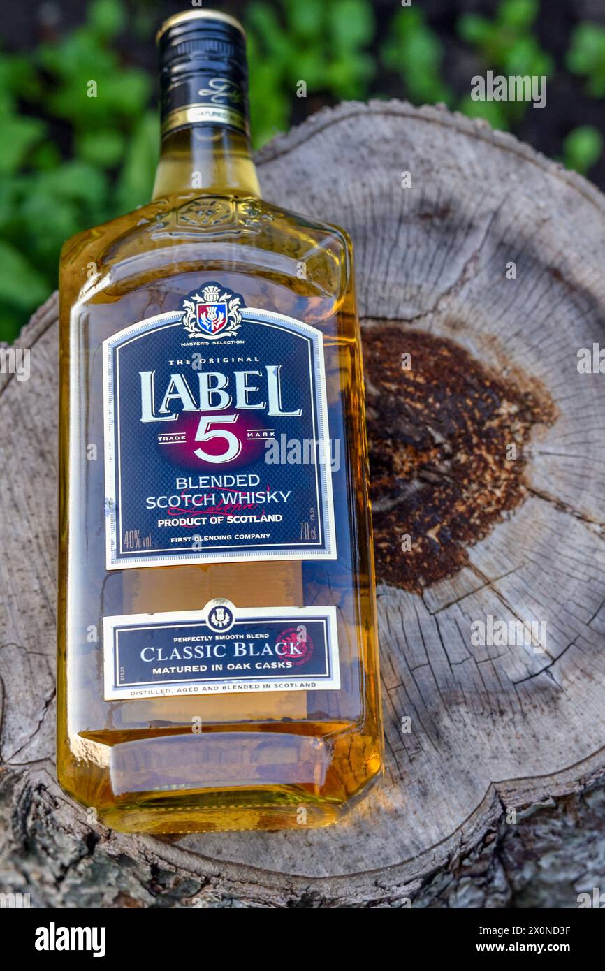 Label 5 Scottish company logo on a bottle of Scotch whiskey lying in nature Edinburgh, Scotland