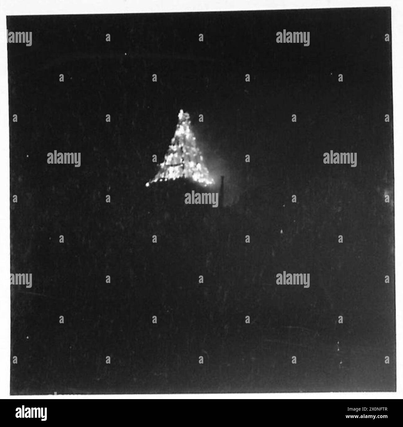 THE BRITISH ARMY IN THE NORMANDY CAMPAIGN 1944 Night time view of a burning chateau near Caen