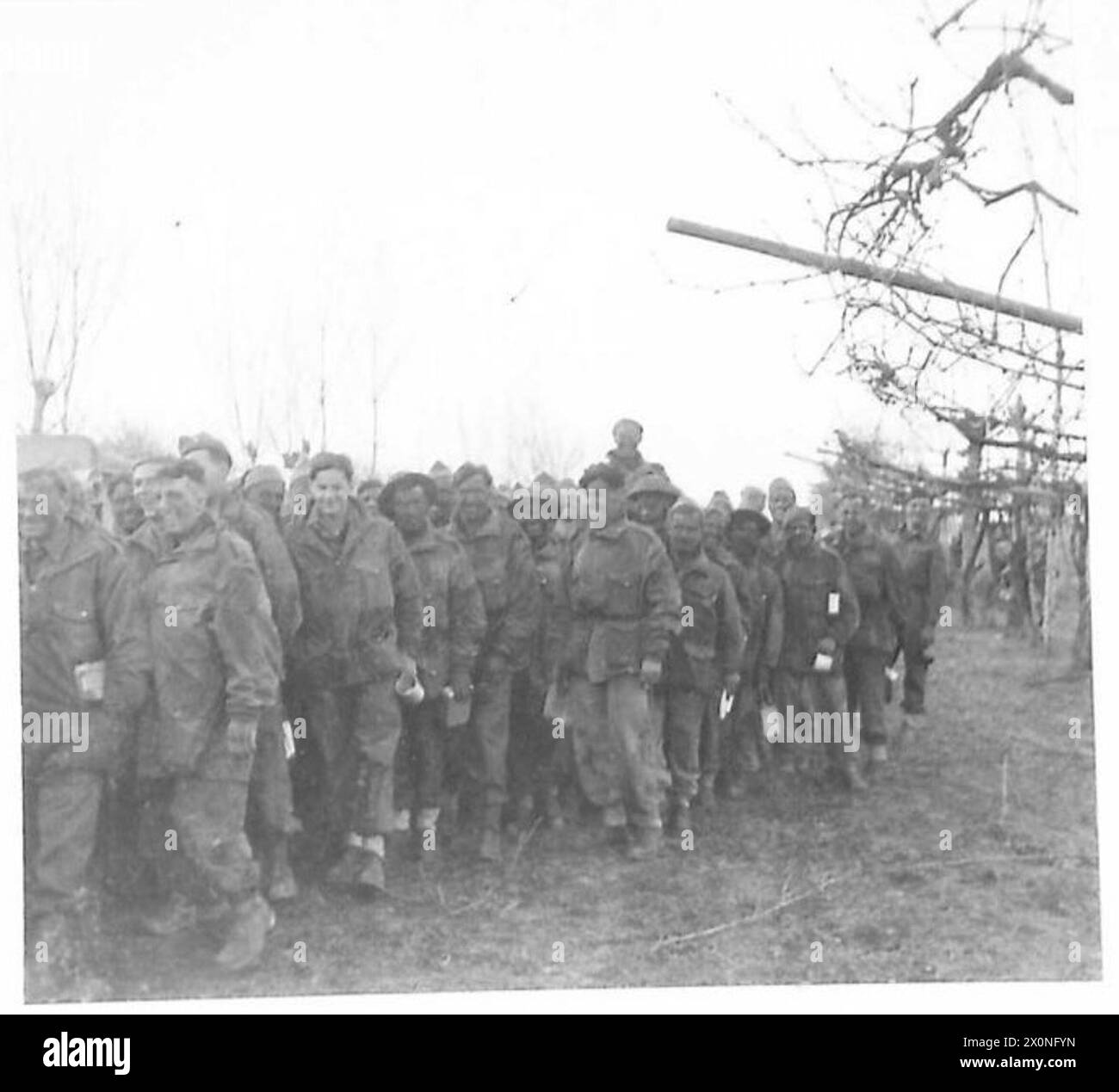 Commandos of the Eighth Army line up for a meal the evening before an attack across marshlands. Stock Photo