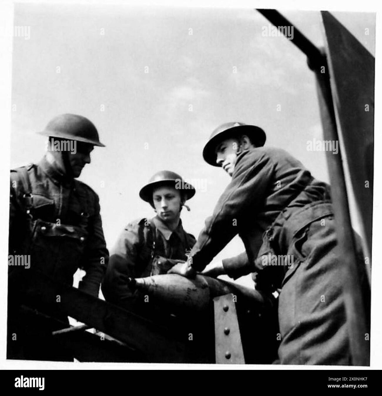 A shell is positioned on the loading cradle ready to be rammed into the ...