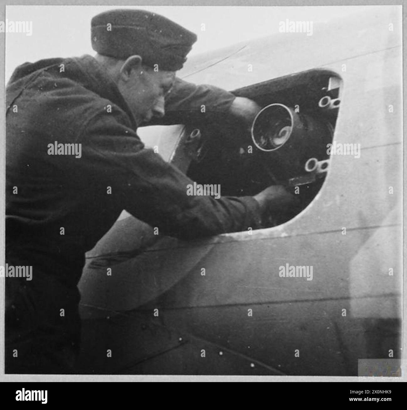 'THE EYES OF THE ARMY' : RAF/ARMY COOPERATION UNIT - Reconnaissance, aerial photography, location of enemy troop concentrations and movements, and spotting for the artillery are among the duties performed by an RAF/Army Cooperation Squadron. American-built Tomahawaks are often used. [Picture issued 1942] Installing the camera on an aircraft of the Unit. Photographic negative , Royal Air Force Stock Photo
