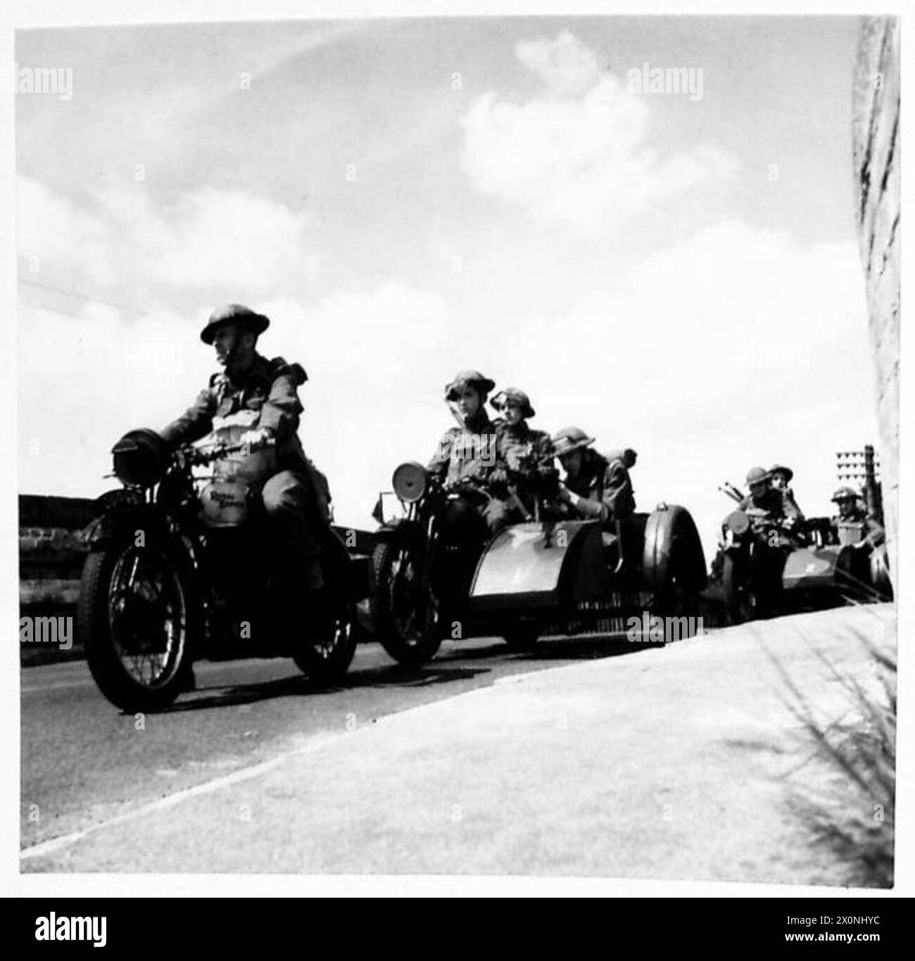 A COMBINED ARMY AND HOME GUARD EXERCISE - A Home Guard motor cycle section on the road during operations. The machines were subscribed for out of subsistence pay of individual Home Guards. The side cars were made to Home Guard specifications. Photographic negative , British Army Stock Photo