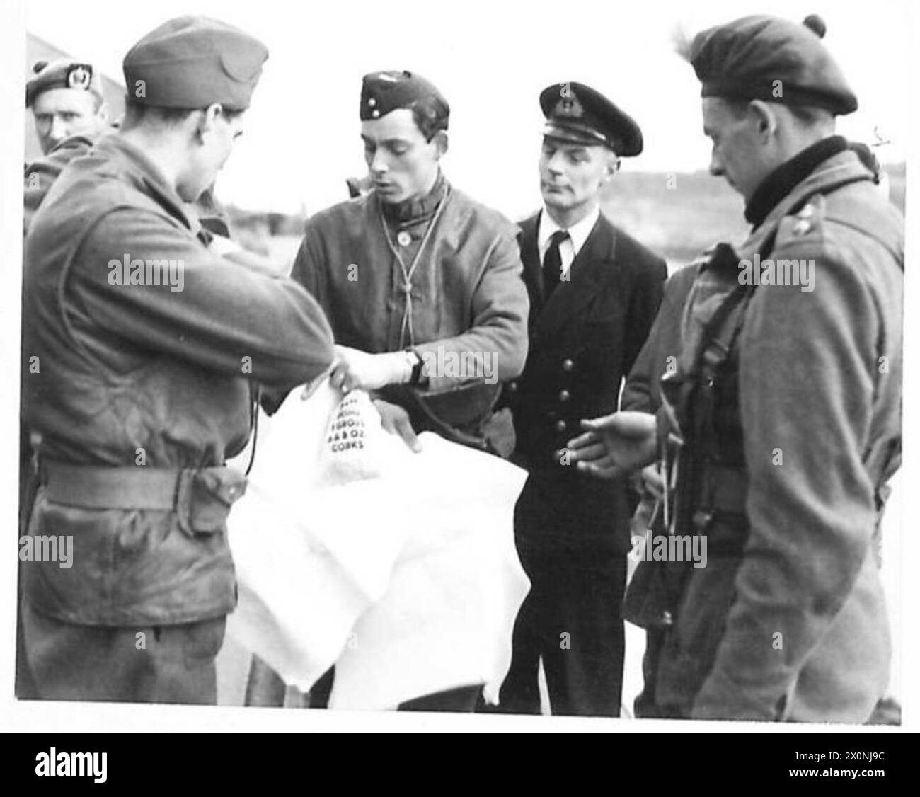 A force commander distributes operational maps to officers during a ...