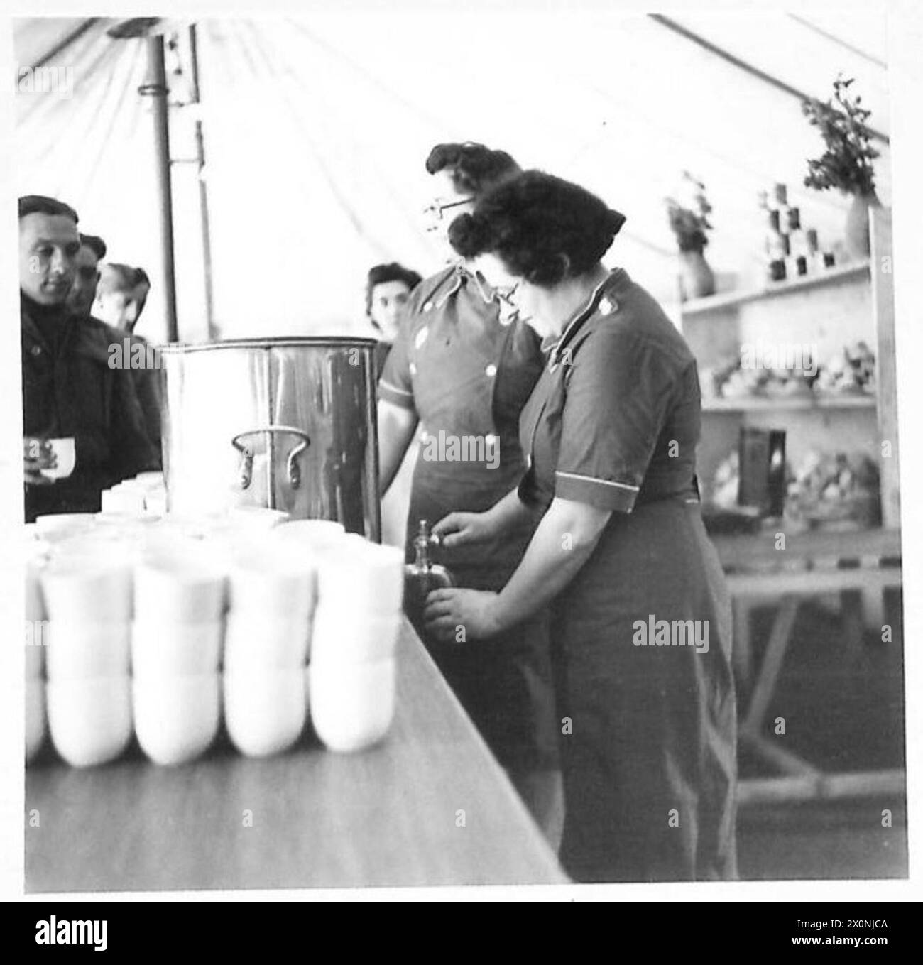 NORTH AFRICA : E.F.I. (NAAFI) SERVICES IN ALGIERS - Serving tea at the Botanical Gardens canteen are:- Miss Bessie Smith of 51 Allander Terrace, Millngrave, Glasgow, and Miss Cathie Muir, 47 York Street, Wishaw, Lanark. Photographic negative , British Army Stock Photo