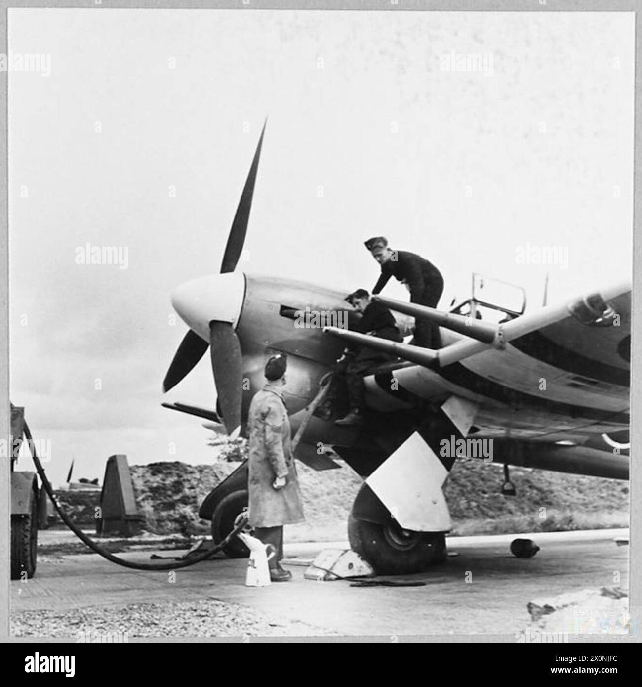Refulled Squadron Leader Scott's Typhoon aircraft is being refuelled in ...