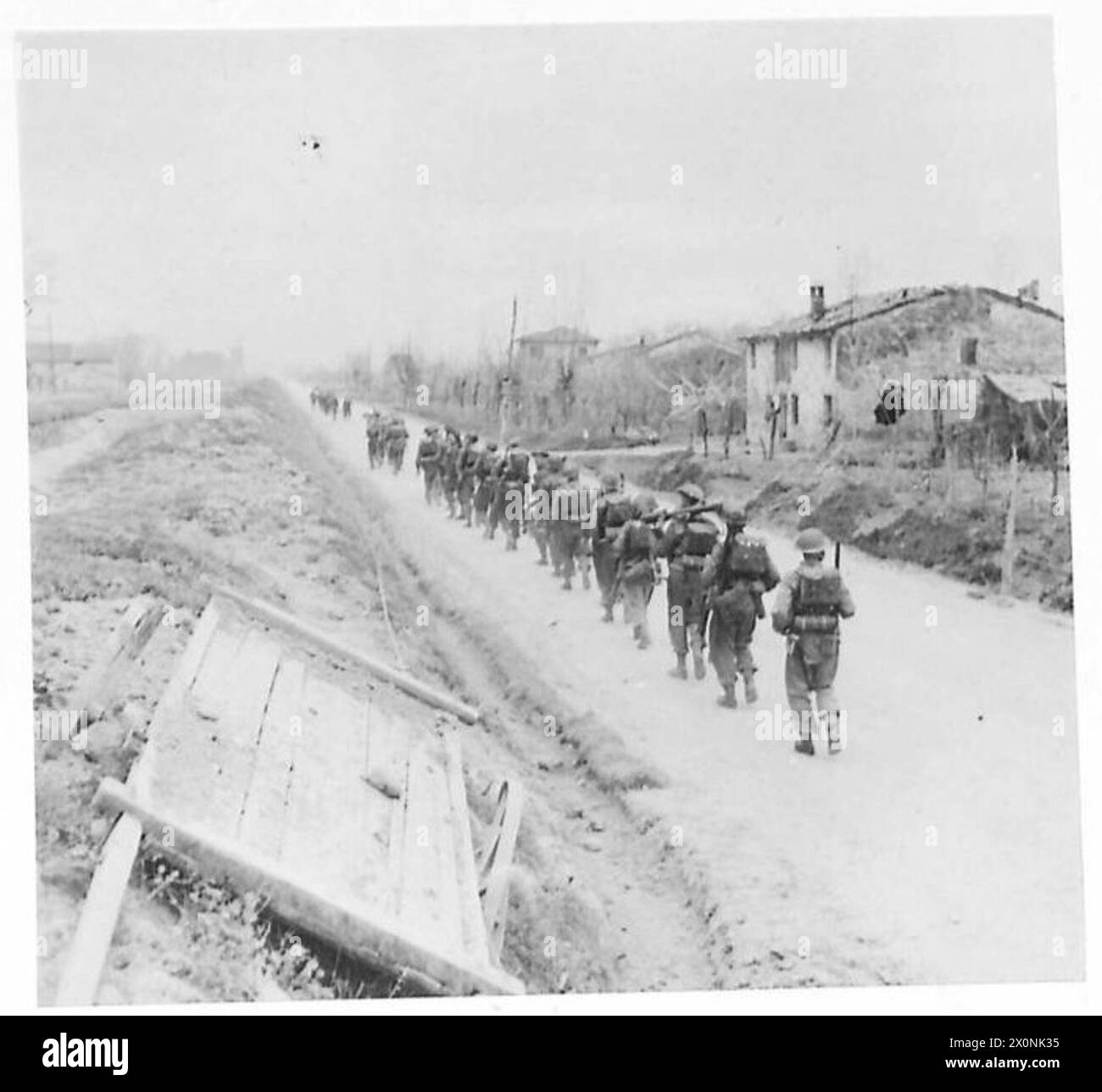 A company of 2 Lancashire Fusiliers, 11th Infantry Brigade, relieves the 38 Irish Brigade on the line during St. Patrick's Day celebrations. Photographic negative by the British Army. Stock Photo