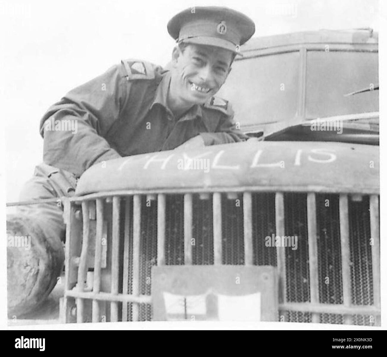 ITALY WITH THE EIGHTH ARMY 'MEN OF ALAMEIN' - A high percentage of the Eighth Army HQ transport us stvill functioning after the gruelling journey over desert tracks, sea voyages and some 400 miles of Italian roads and lanes. Here is Signalman R. Warburton - 8th Army Signals - of 10, Huntroyde Avenue, Bolton, Lancs, who has driven his 8 cwt. Dodge on express letter service all the way. The truck bears the name of his wife on the radiator. He has a daughter who was 6 months old when he last saw her. Photographic negative , British Army Stock Photo