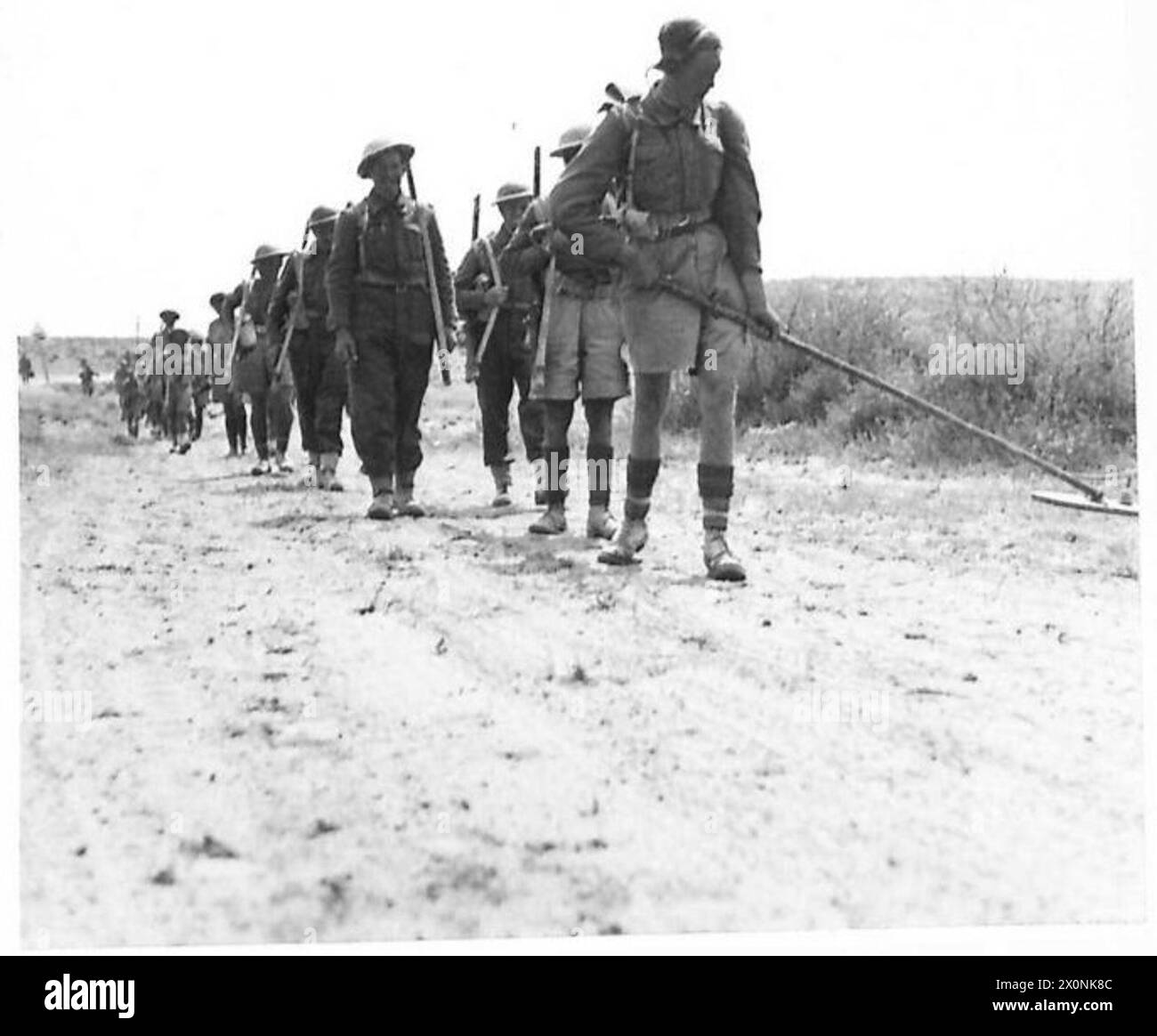 Durham Light Infantry soldiers advance behind a mine detector during the Eighth Army’s attack and capture of the Mareth Line in World War II. Stock Photo