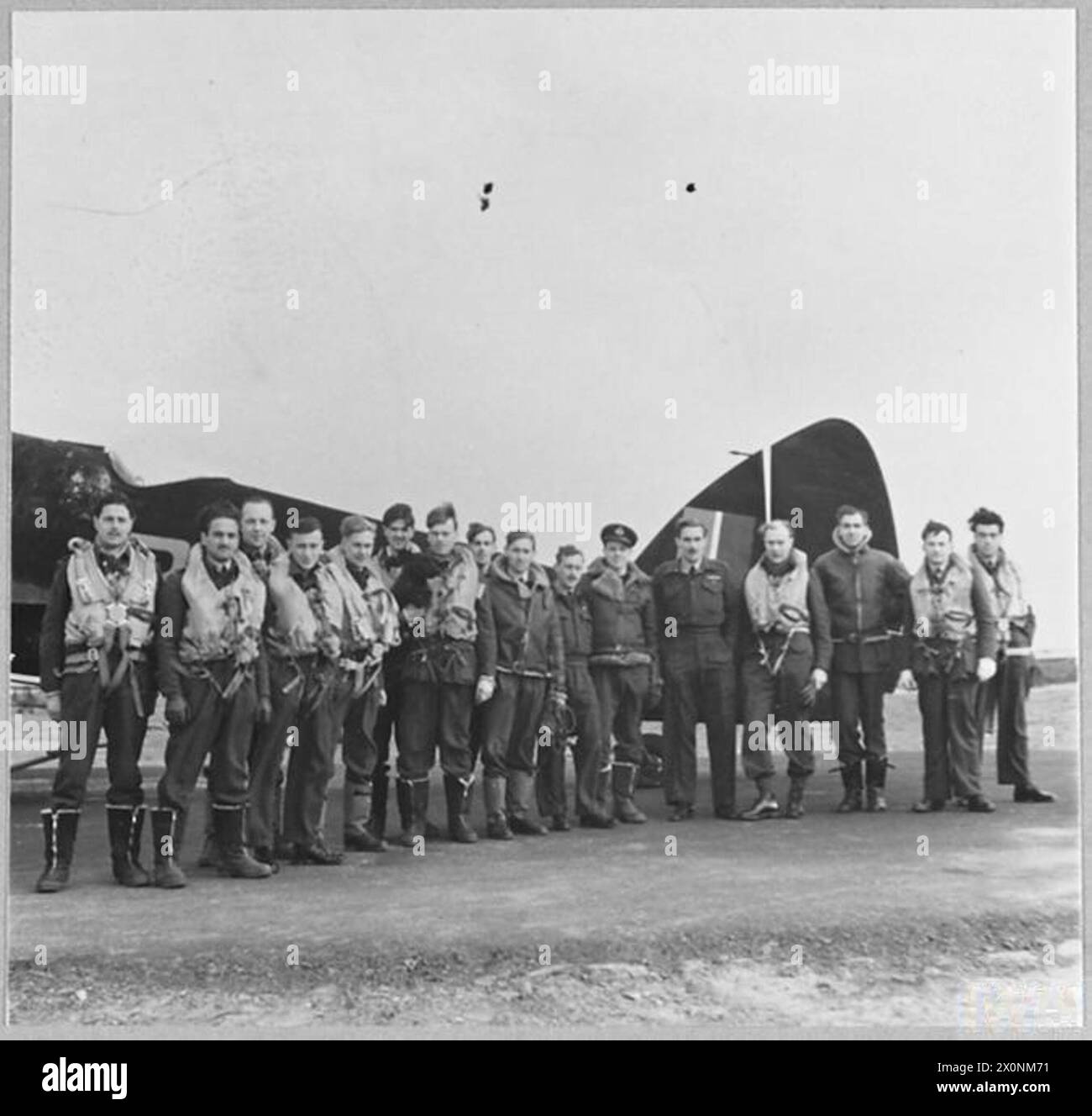 PERSONNEL OF R.A.F. NIGHTFIGHTER SQUADRON COMBATING 'BAEDEKER' RAIDS. - Beaufighters powered with Hercules engines are used with a night fighter squadron which has been engaged in combating enemy aircraft in the 'Baedeker' raids on this country. Pilots and observers of the squadron, many of them wearing the ribbon of the D.F.C. Photographic negative , Royal Air Force Stock Photo