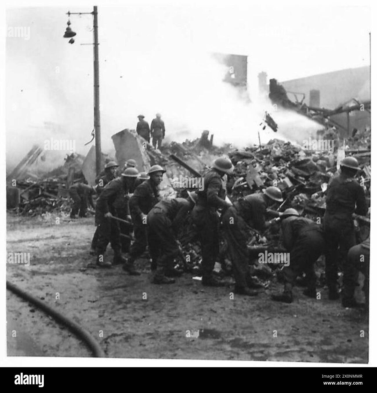 British Army soldiers assist in clearing debris after bomb damage in ...