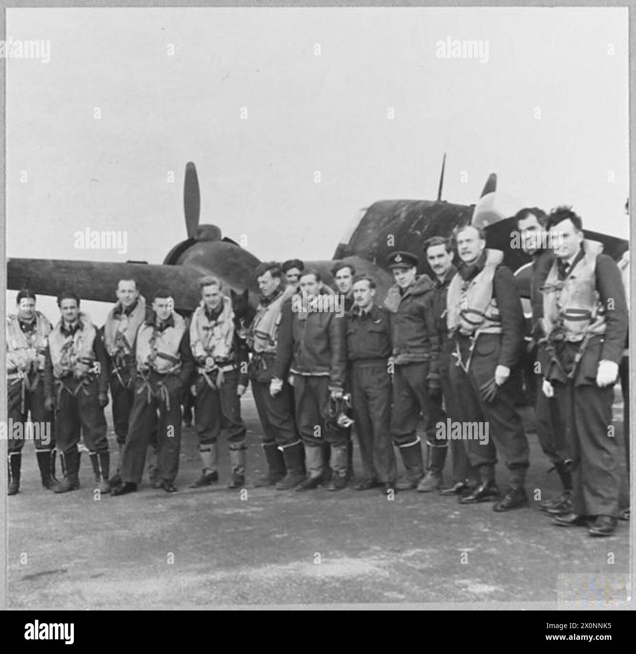 PERSONNEL OF R.A.F. NIGHTFIGHTER SQUADRON COMBATING 'BAEDEKER' RAIDS. - Beaufighters powered with Hercules engines are used with a night fighter squadron which has been engaged in combating enemy aircraft in the 'Baedeker' raids on this country. Pilots and observers of the squadron, many of them wearing the ribbon of the D.F.C. [LEFT] Sergeant Scobie; Pilot Officer H. Duncan; Sergeant Georgeson; Sergeant I. Boyd; SergeantPeacock Jake and Flight Lieutenant A.J. Clegg, DFC; Pilot Officer J. McD.Craig; Flight Lieutenant H.v. Ellis; Sergeant A.Webber; Sergeant Clarke; Pilot Officer H.W. Yielder; S Stock Photo