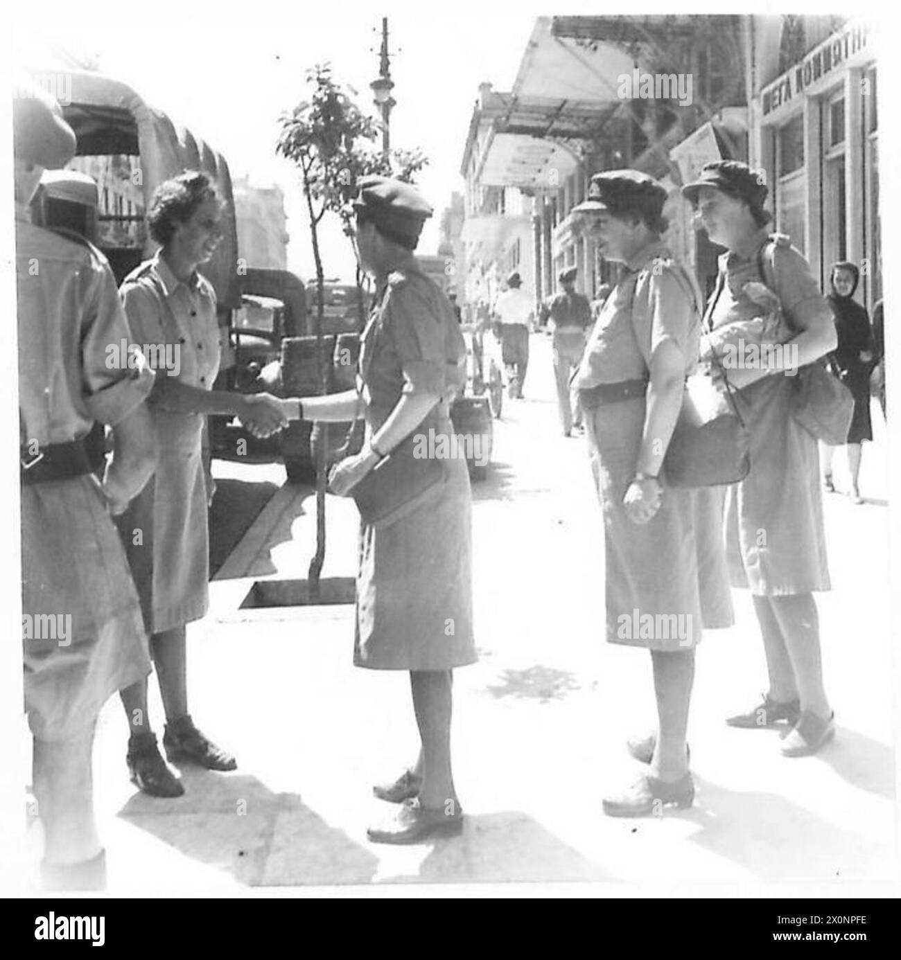 CHIEF CONTROLLER WHATELEY VISITS THE NAAFI IN ATHENS - Chief Controller Whateley being greeted by an A.T.S. sergeant at the NAAFI. Photographic negative , British Army Stock Photo