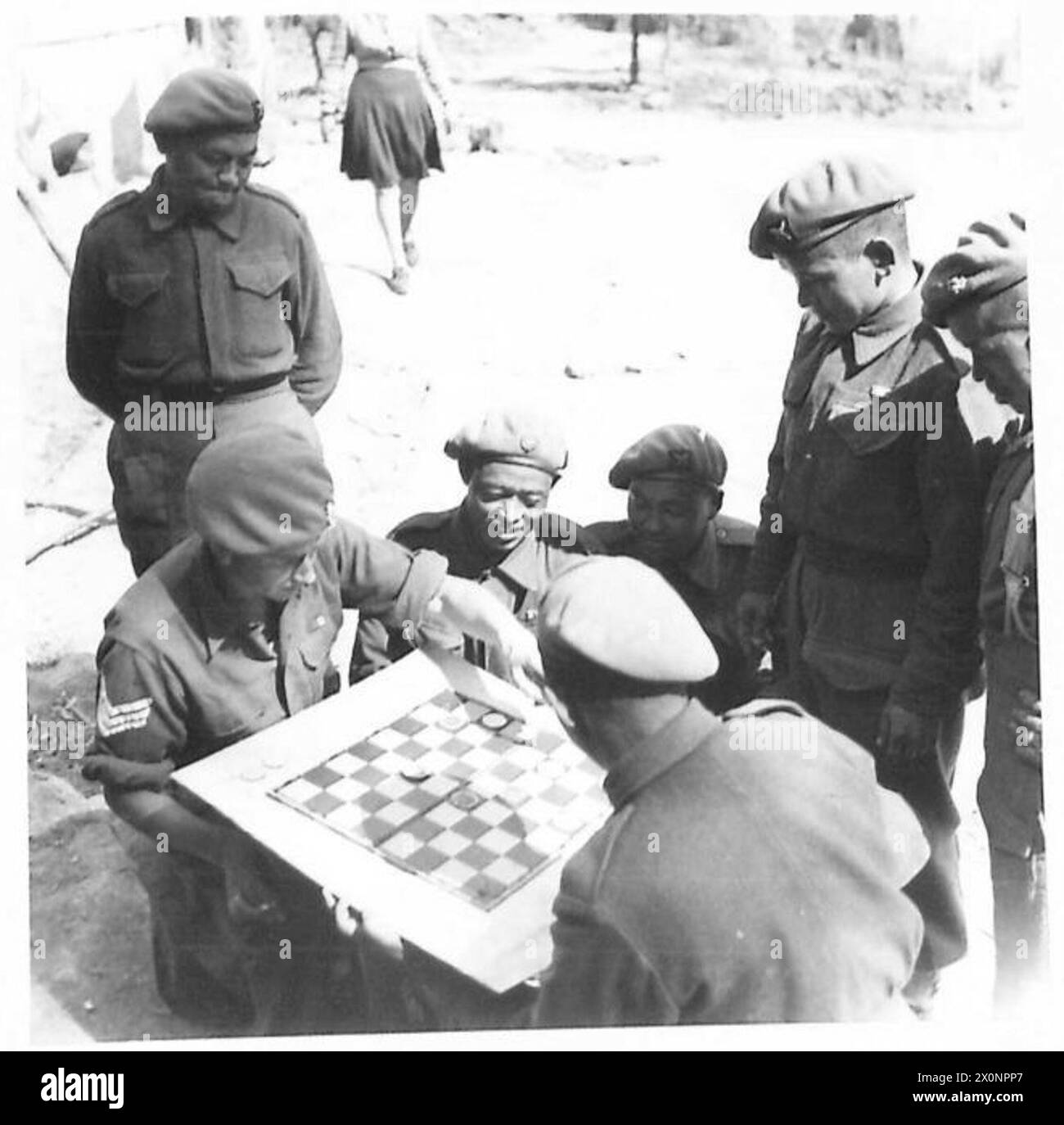 EIGHTH ARMY : THE GURKHAS - A favourite recreation of the Gurkhas is draughts at which they excel. Here, Sgt. Eric Parker of 38 Shipley Road, Broxtowe, Nottingham, plays against a Gurkha. Sgt.Parker is a married man with a daughter ages 2j years. He has 6 years service with the Sherwood Foresters. He was in the Norway Expeditionary Force , was cut off and made for the Swedish border. He was interned in Sweden for 2 1/2 months, then returned to England. He has been in Italy since April 1944 and was at Anzio. Photographic negative , British Army Stock Photo