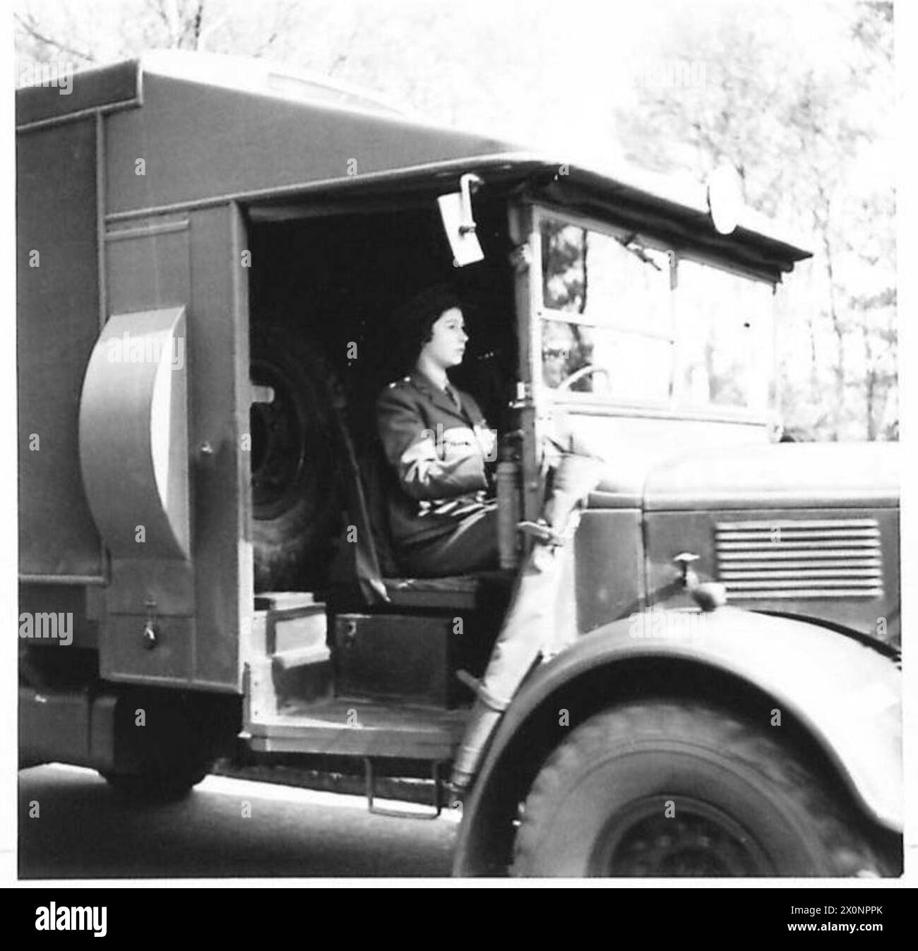 negative - H.R.H. seated at the wheel of an ambulance. Photographic negative , British Army Stock Photo