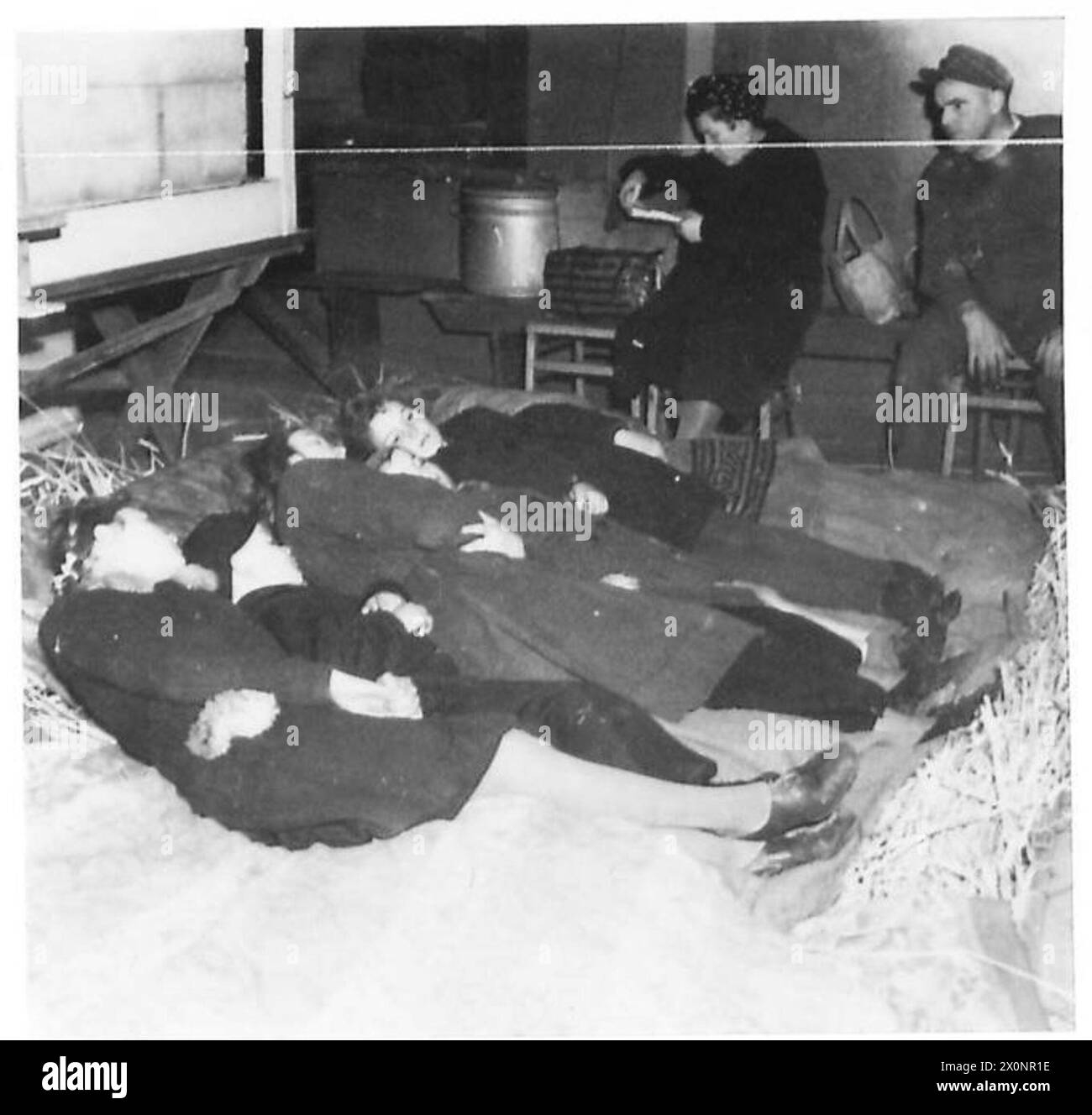 CIVILIAN EVACUATION FROM THE RUHR AREA - Gerda Hermani and the junior members of the family resting after their journey. Photographic negative , British Army of the Rhine Stock Photo