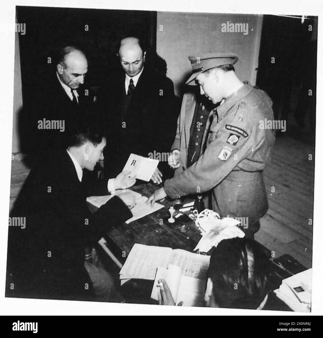 GREEK ELECTIONS - A British Observer Officer (AMFOGE) observes the checking of voters at one of the many polling stations around Athens. Photographic negative , British Army Stock Photo