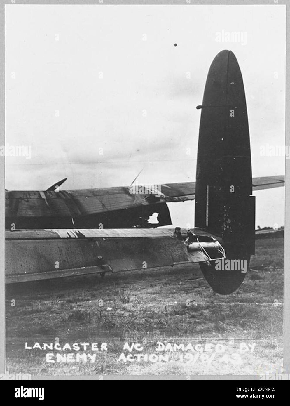 DAMAGED LANCASTER BOMBS TARGET AND RETURNS SAFELY FROM PEENEMUNDE. - For story see CH.10914. Damage to the starboard wing and tailplane. Photographic negative , Royal Air Force Stock Photo