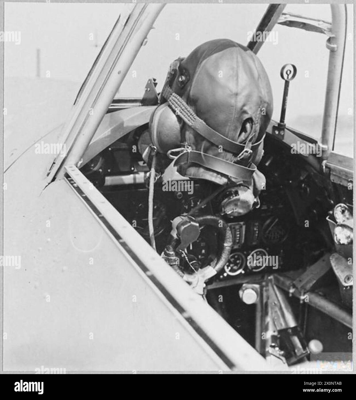 THE BATTLE OF THE ATLANTIC - 'Still' life. The pilot's helmet hangs near the control column. Photographic negative , Royal Air Force Stock Photo