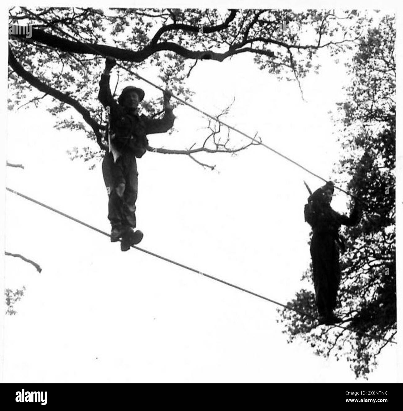 Members of Parliament observe soldiers crossing a rope bridge set up ...
