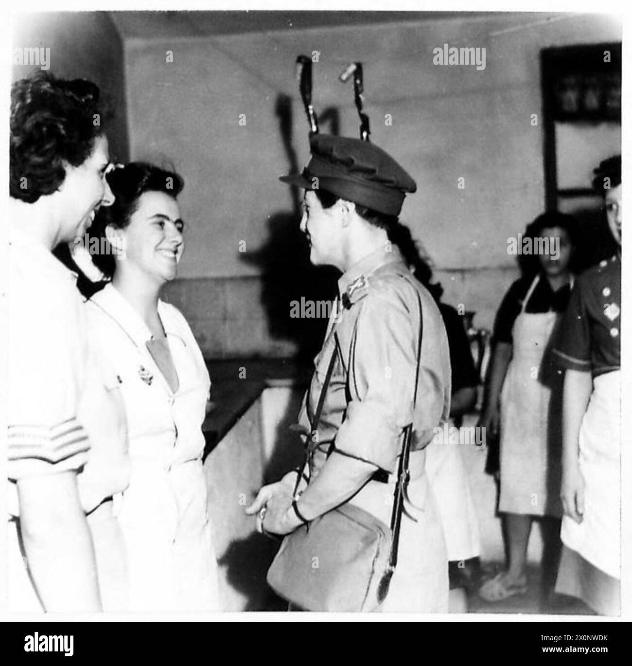 CHIEF CONTROLLER WHATELEY VISITS THE NAAFI IN ATHENS - Chief Controller Whateley talking to a W.V.S. worker in the NAAFI canteen. Photographic negative , British Army Stock Photo