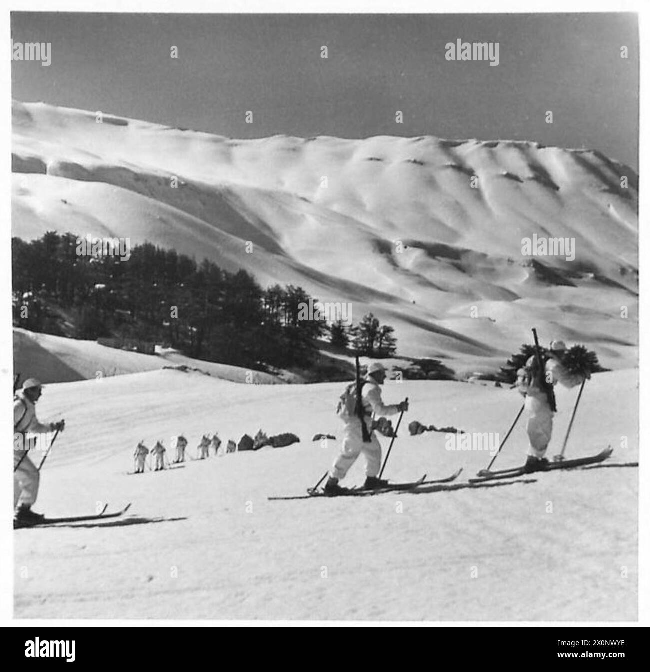 SKI TROOPS IN TRAINING - A party of ski troops making an ascent from their H.Q. Photographic negative , British Army Stock Photo
