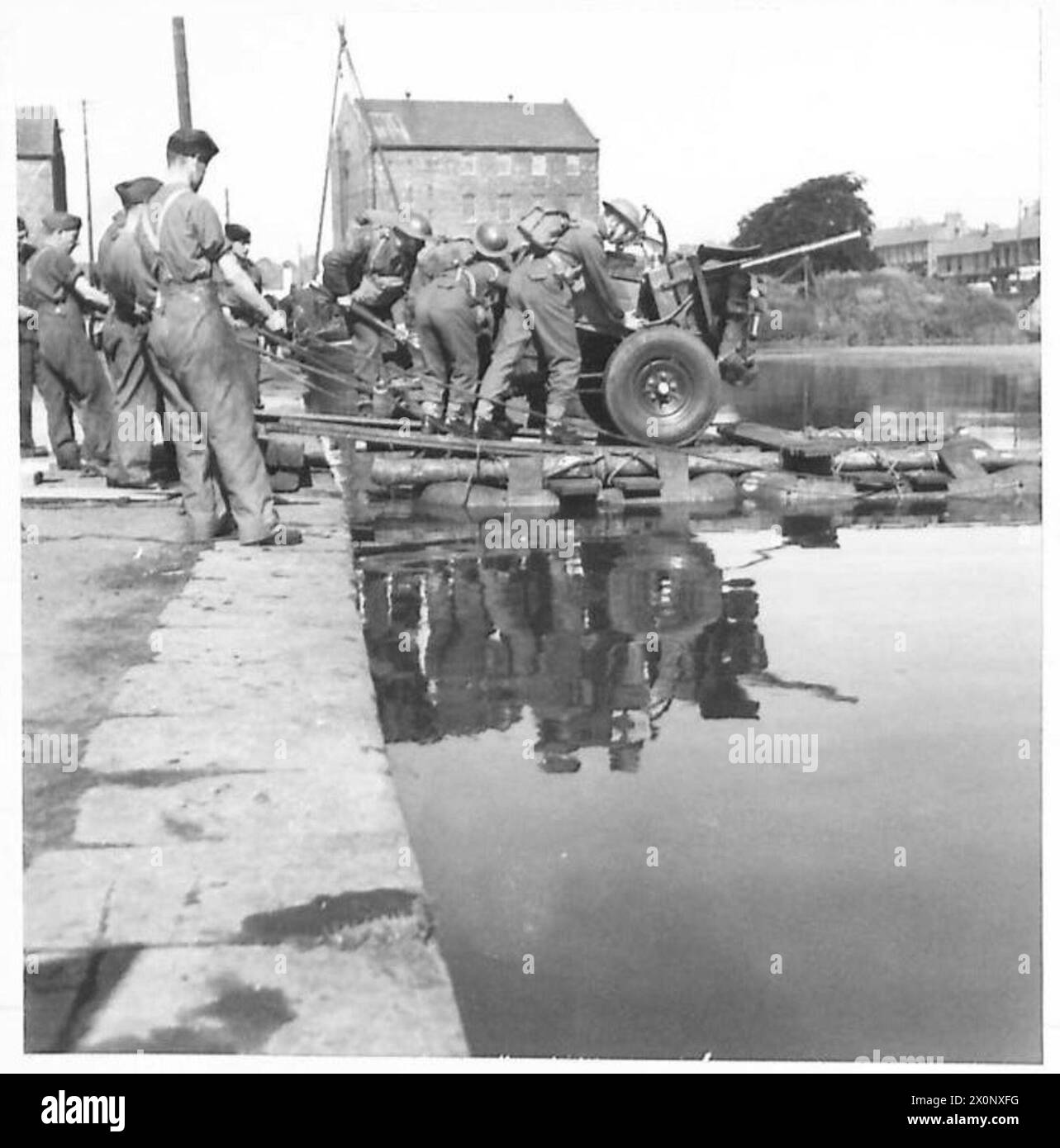 IMPROVISED RAFTS FOR GUNS Loading the gun on the raft. Photographic
