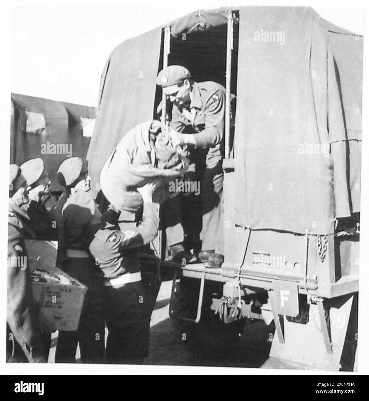 EIGHTH ARMY : THE ROAD HOME - Cpl. Cook and Rfn. Blackman climb into a transport. Photographic negative , British Army Stock Photo