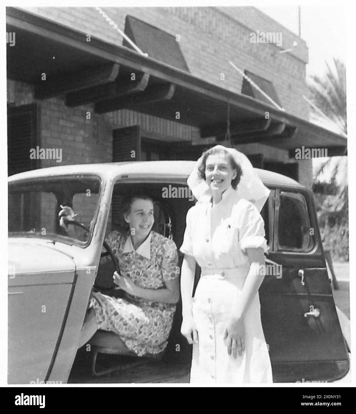 PICTURES FROM IRAN (PERSIA) - Two nurses who were mixed up in the fighting in the refinery area; seated in the car is Miss Amy James and Miss Elizabeth Fitzsimmons from Ayr. Miss James comes from Chesterfield. Photographic negative , British Army Stock Photo