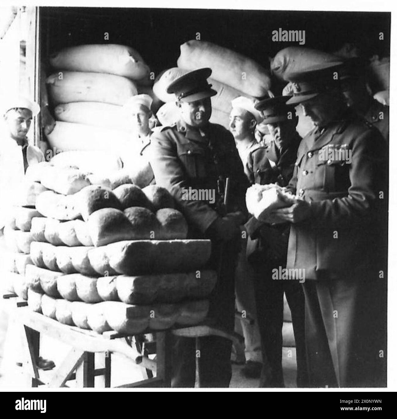 BAKING THE ARMY'S BREAD - The Commanding Officer testing the bread ...