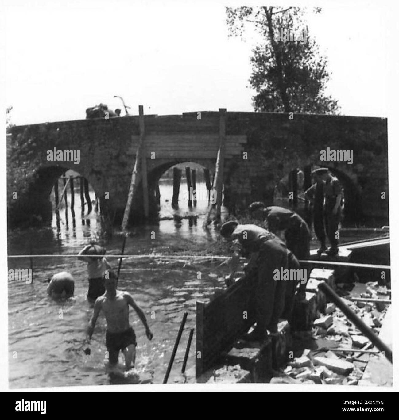 Three members of the 183 Field Company, Royal Engineers, work on a ...