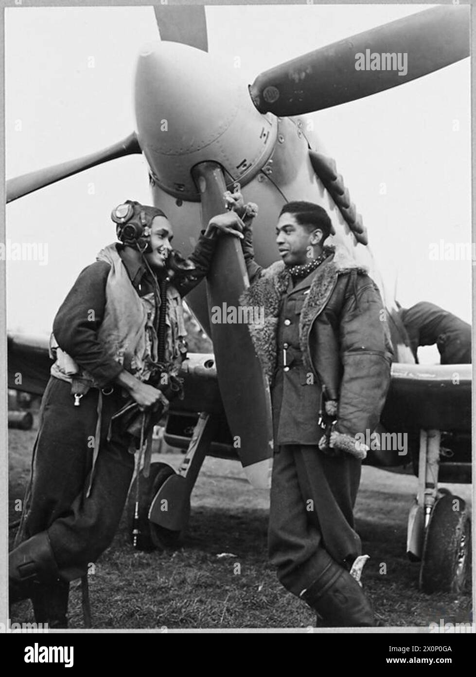 WEST INDIAN SPITFIRE PILOTS - Flight Sergeant Colin A. Joseph of San Fernando, Trinidad [right] and Pilot Officer Arthur O'Brien Weeks of St. George, Barbados [left] fly Spitfires in the City of Bombay Squadron. Picture issued 1944. Photographic negative , Royal Air Force Stock Photo