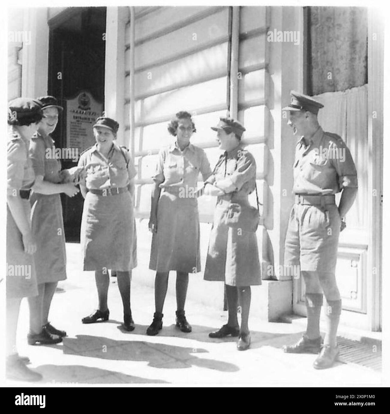 CHIEF CONTROLLER WHATELEY VISITS THE NAAFI IN ATHENS - Outside the NAAFI with her staff Photographic negative , British Army Stock Photo