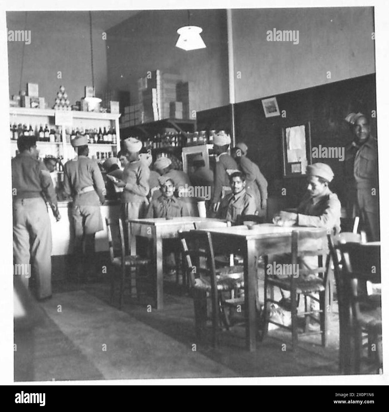 AMONG THE TROOPS IN CYPRUS - Indians buying stores from a NAAFI in Cyprus Photographic negative , British Army Stock Photo