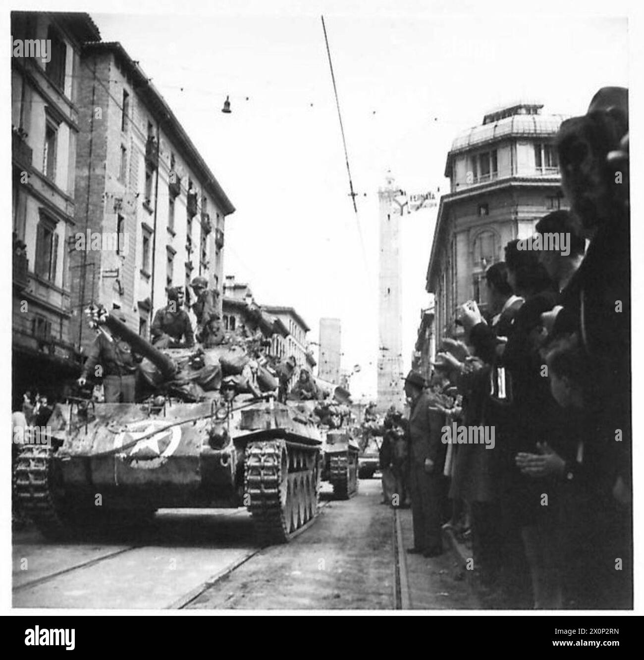 BOLOGNA : VARIOUS - Huge crowds of Bolognese citizens clap and cheer as armour passes through the streets. Photographic negative , British Army Stock Photo