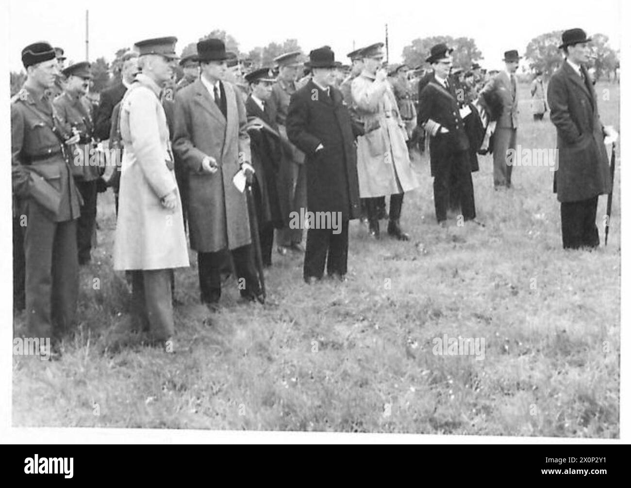 PRIME MINISTER AT GUNNERY DEMONSTRATION - Lord Beaverbrook; Captain D. Margesson; Sir Archibald Sinclair; Admiral of the Fleet Sir Roger Keyes; General Sir John Dill, Chief of the Imperial General Staff; and other officers watching the demonstration. Photographic negative , British Army Stock Photo