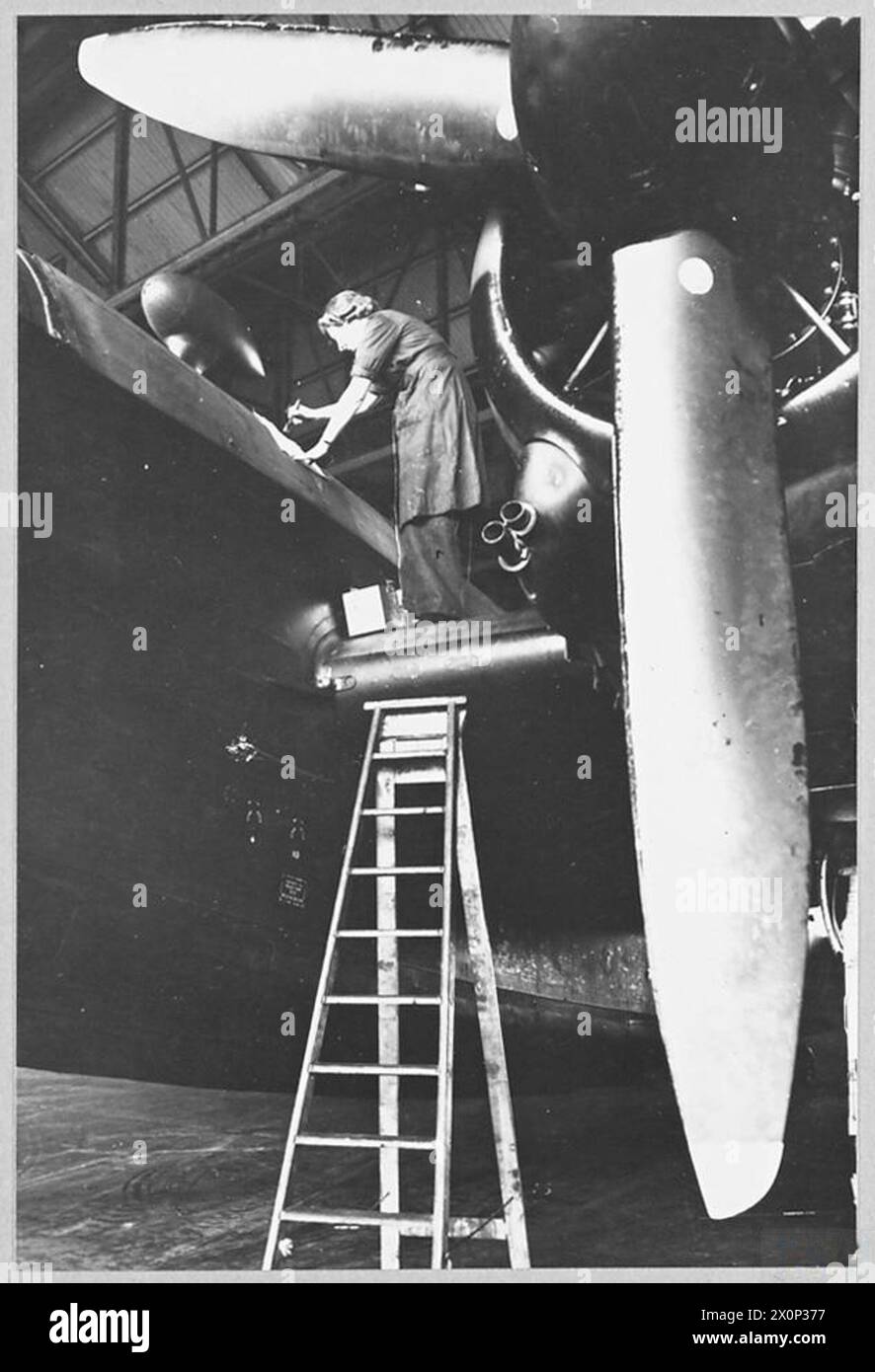 WORK OF W.A.A.F. AT BOMBER STATIONS - For story see CH.13702 Picture (issued 1944) shows - A fabric worker painting the fuselage of a Wellington with protective dope. Photographic negative , Royal Air Force Stock Photo