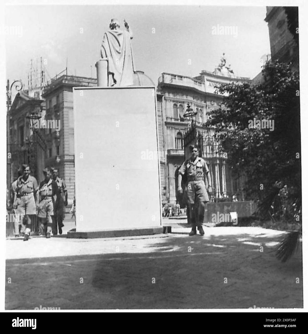 ITALY : 'PTE.SMITH' COMES TO TOWN - Pte. Smith walks past the statue as he passes through the gates into the NAAFI. Photographic negative , British Army Stock Photo