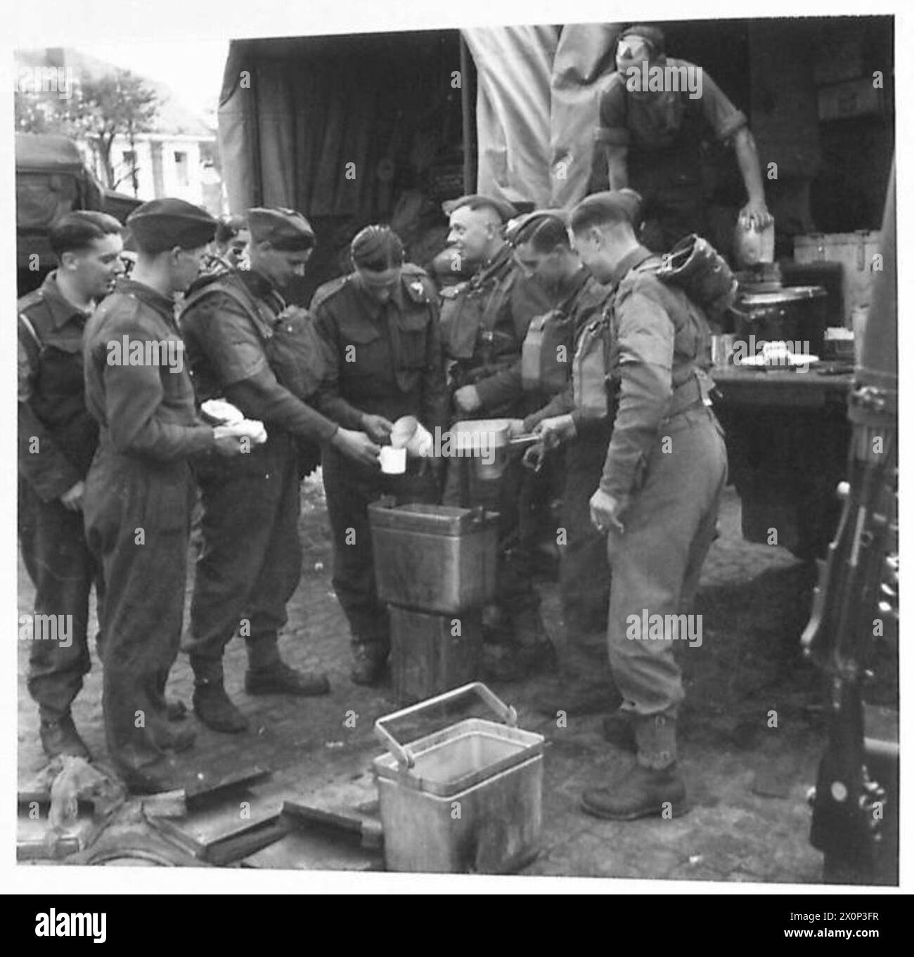 'BUMPER'EXERCISE - Troops being fed from a mobile kitchen in the market square of a country town. Photographic negative , British Army Stock Photo
