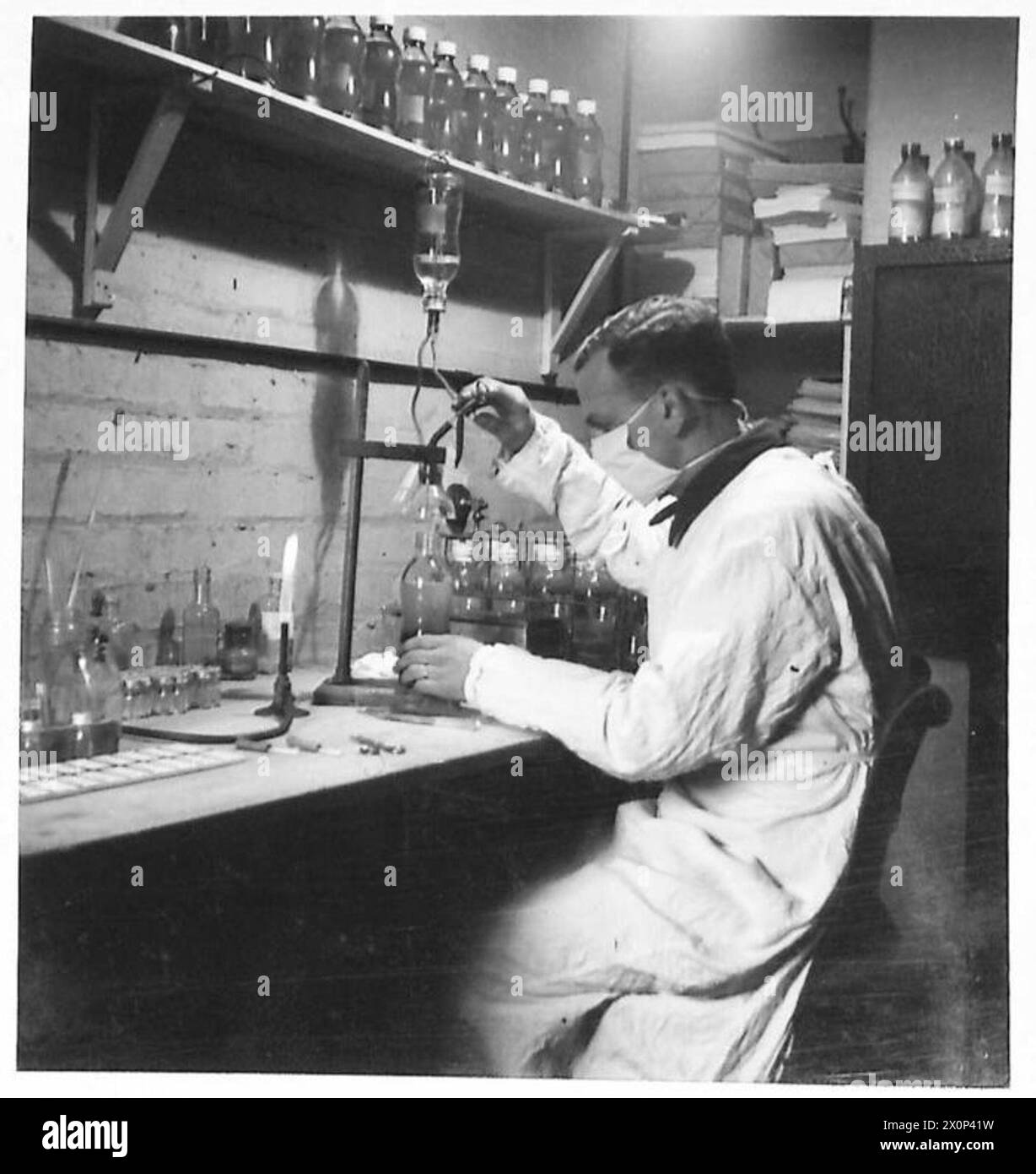 Photographic negative showing Army laboratory services adding sugar solution to bottled blood for storage purposes. Stock Photo