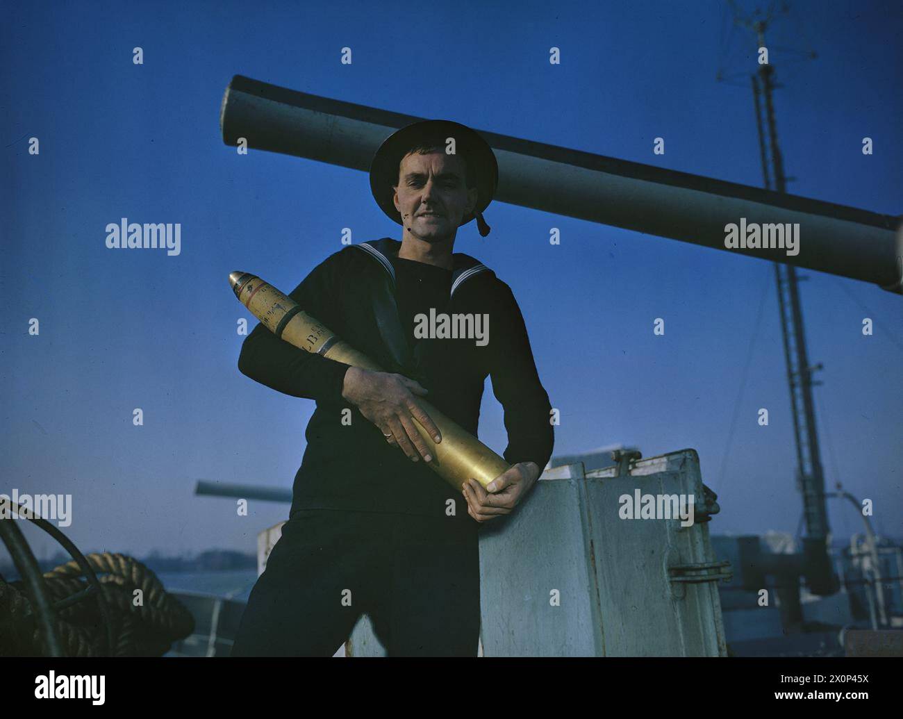 A Royal Navy Gunner Is Shown Holding A Shell The Photograph Documents A Royal Navy Gunner Is Shown Holding A Shell The Photograph Documents