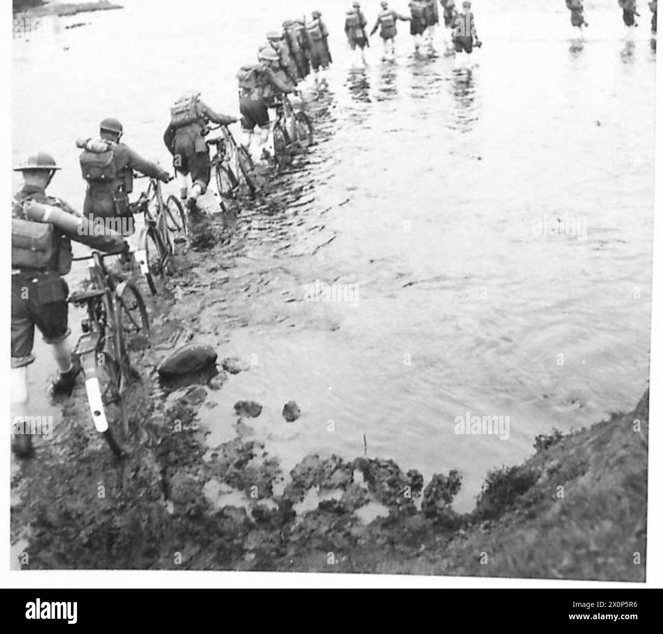 Cyclists are shown fording a river during an Ulster military exercise ...