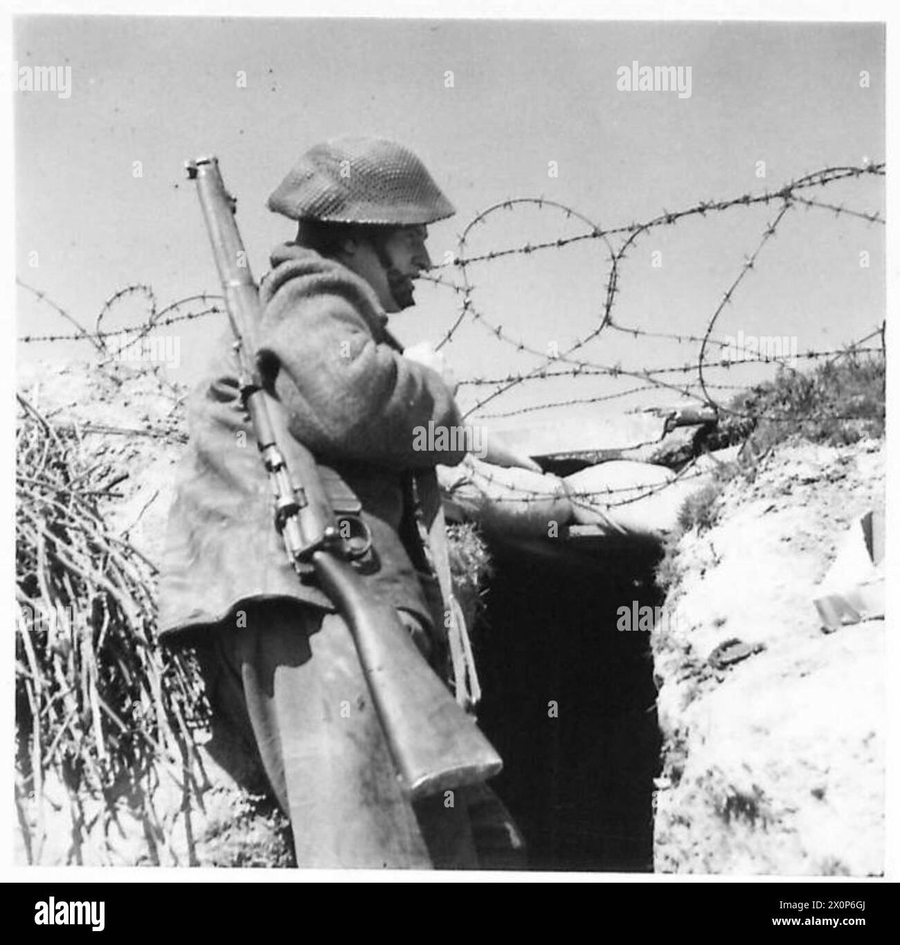 THE BRITISH ARMY IN NORTH AFRICA, SICILY, ITALY, THE BALKANS AND AUSTRIA 1942-1946 - Tpr. Merridy of 16 Union Street, Hulme, Manchester, keepes a good look-out across the river Reno. Photographic negative , British Army Stock Photo