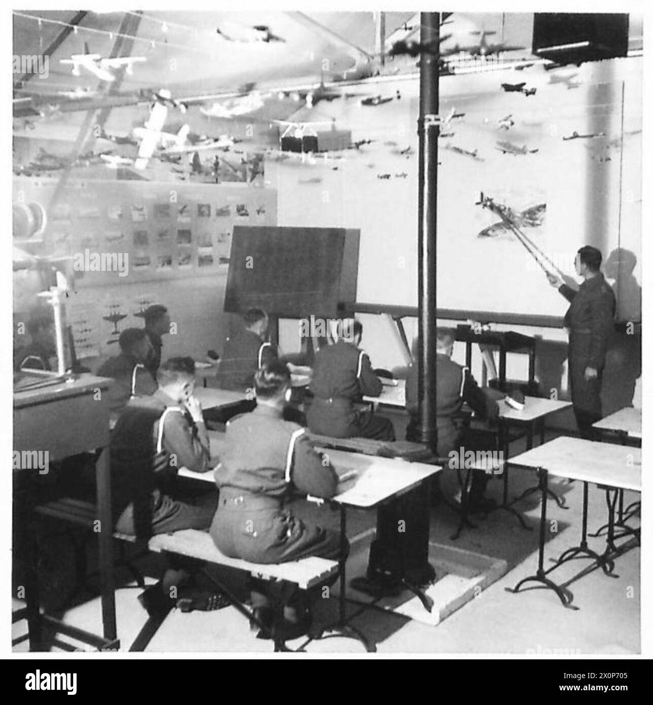 WESTERN COMMAND O.C.T.U. - The aircraft recognition room, with cadets attending alecture. An epidiascope is used to project aircraft pictures on a screen for identification. Photographic negative , British Army Stock Photo