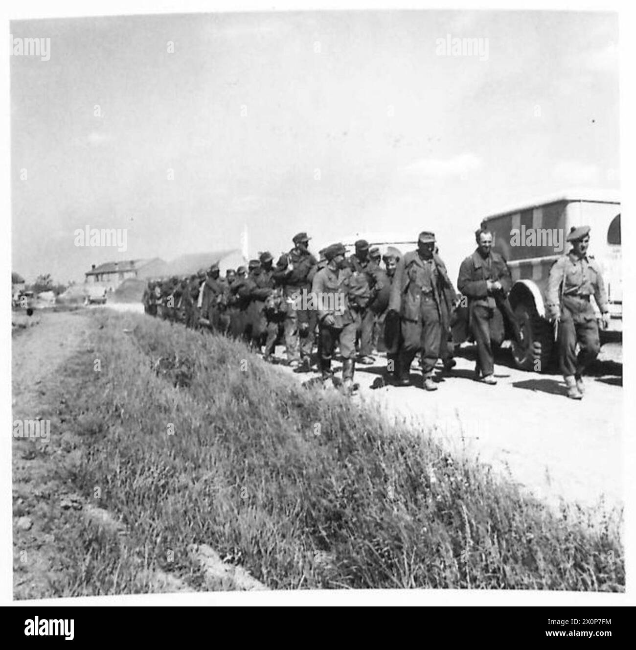 German prisoners of war are marched to the rear by the British Eighth ...