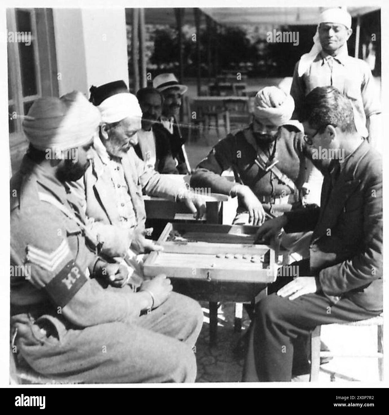 AMONG THE TROOPS IN CYPRUS - Indians in Cyprus watching a game of Tavli being played by Greeks. Photographic negative , British Army Stock Photo