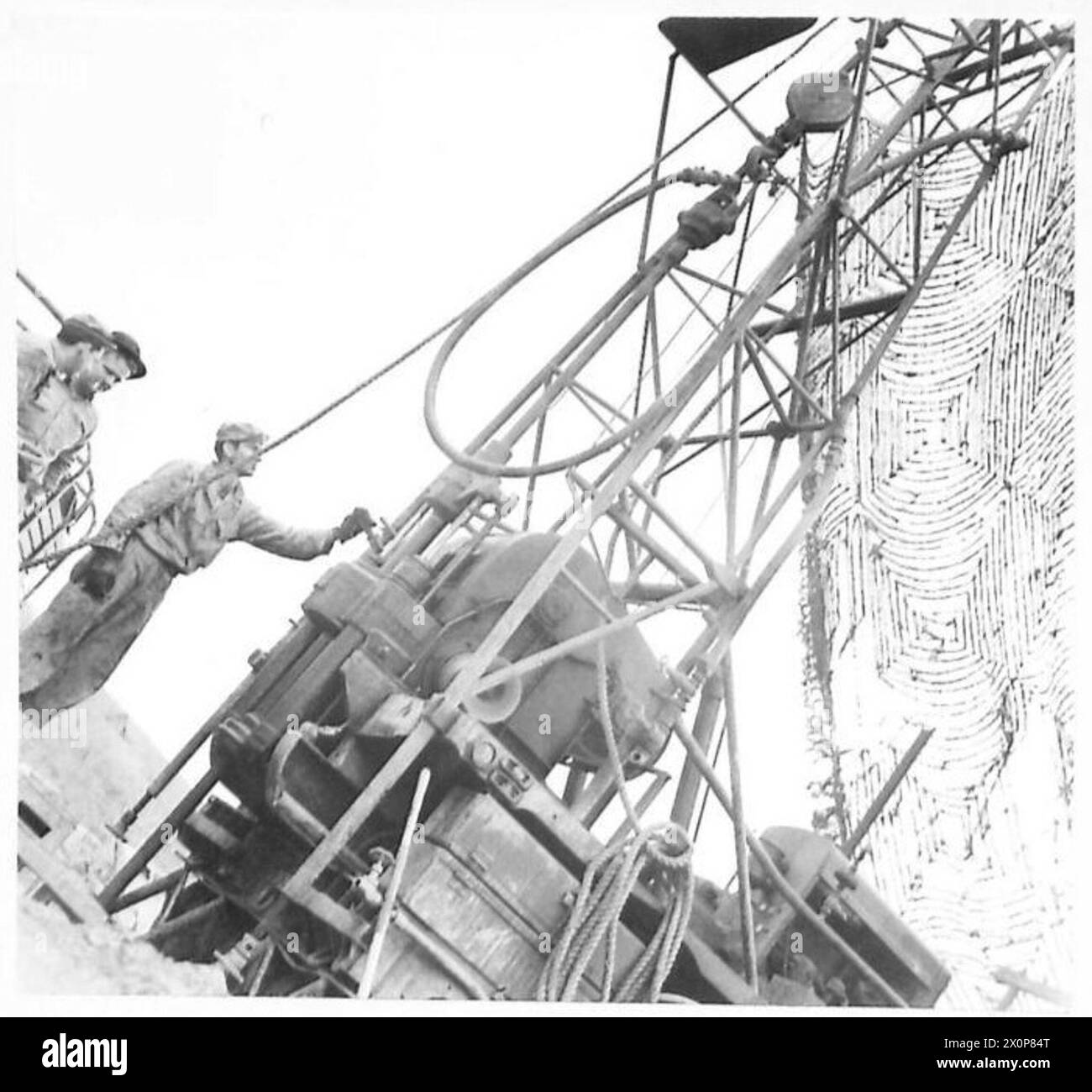 THE BRITISH ARMY IN NORTH AFRICA, SICILY, ITALY, THE BALKANS AND AUSTRIA 1942-1946 - Although it has been raining in the Cassino area for a long time good drinking water has as high value. Wells are being drilled to a depth of 250 feet by 405 Engineers, U.S.Army. The job takes 2 to 3 days. This picture shows the drilling machine at work. Photographic negative , British Army Stock Photo