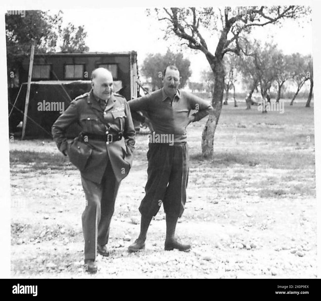 Generals Wilson and Leese are photographed together while discussing the battle situation during a visit to the 8th Army in the Mediterranean theatre, Italy. Stock Photo