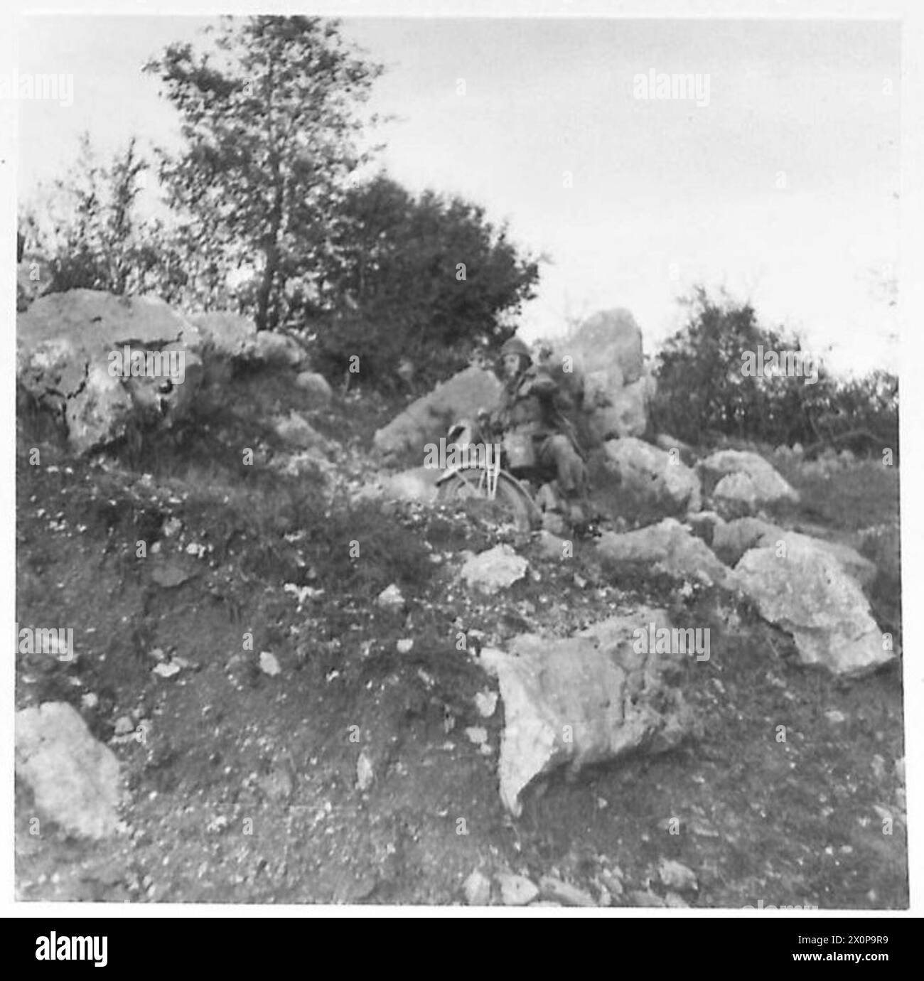Photograph of an Eighth Army despatch rider taking a narrow, rocky ...