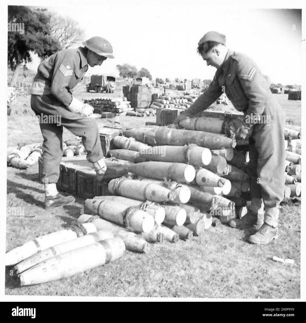 ITALY : FIFTH ARMYSUPPLIES FOR ANZIO BRIDGEHEAD - Checking shells at an ammo dump; left to right - S/Sgt. J. Elrick of 8 Union Street. Stirling Cpl. J. Muir of 72 Avon Bank Road, Rutherglen, Glasgow Photographic negative , British Army Stock Photo