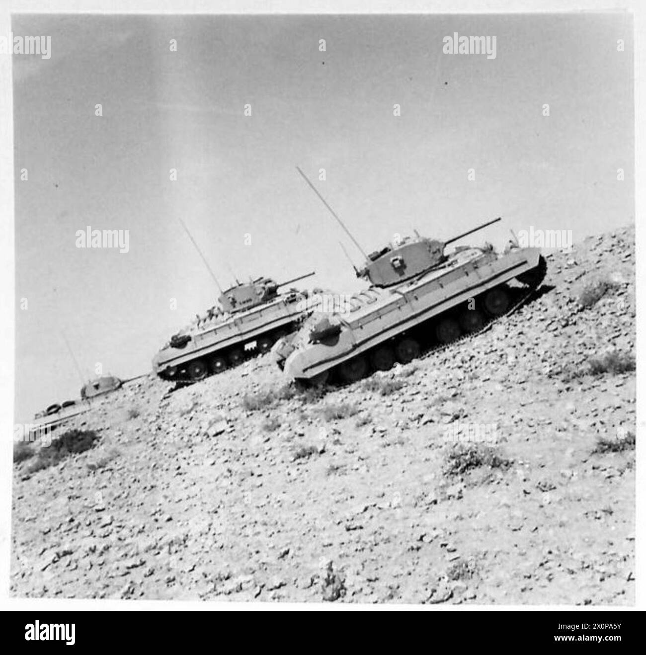 Photograph showing a formation of tanks ascending a hill, demonstrating ...